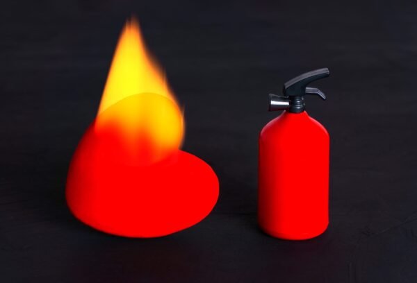 A stylized minimalist 3D rendering of a red fire extinguisher next to an abstract red shape engulfed in yellow flame.